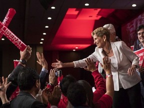 Ontario Premier Kathleen Wynne greets attendees as she takes to the stage to address the Ontario Liberal Party's annual general meeting in Toronto on Saturday, February 3, 2018.