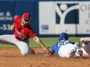 New York Mets' Kevin Plawecki, right, is tagged out at second by St. Louis Cardinals shortstop Paul DeJong Saturday, Feb. 24, 2018, in Port St. Lucie, Fla. (AP Photo/Jeff Roberson)