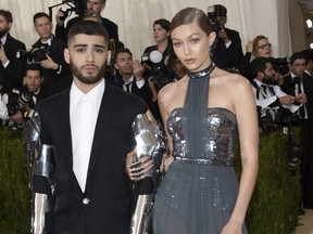In this May 2, 2016 file photo, Zayn Malik, left, and Gigi Hadid arrive at The Metropolitan Museum of Art Costume Institute Benefit Gala in New York. Hadid and Malik are confirming on social media that their romance is over. The 22-year-old model and 25-year-old musician each posted on Twitter Tuesday about the end of their two-year relationship.