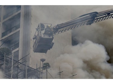 Firemen prepare to search for trapped hotel employees following a fire at the Manila Pavilion Hotel and Casino Sunday, March 18, 2018 in Manila, Philippines. (AP Photo/Bullit Marquez)