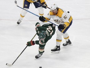 Minnesota Wild's Eric Staal (12) tries to control the puck against Nashville Predators' Ryan Johansen (92) in the first period of an NHL hockey game Saturday, March 24, 2018, in St. Paul, Minn.