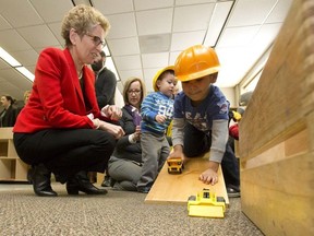 In this file photo, Ontario Premier Kathleen Wynne plays with Marcus Sztrum as she tours the White Oaks Family Centre before announcing the launch of Ontario Early Years Child and Family Centres in London, Ont. on Friday February 19, 2016.