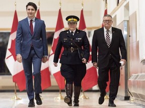Brenda Lucki, center, Prime Minister Justin Trudeau, left, and Ralph Goodale, minister of public safety and emergency preparedness enter a press event at RCMP "Depot" Division in Regina, Saskatchewan on Friday March 9, 2018.