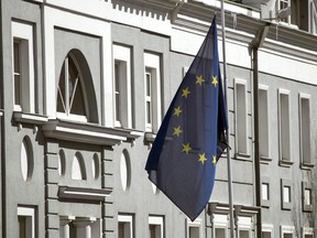 The European Union flag flies in front of the European Union mission in Moscow, Russia, Wednesday, March 28, 2018. More than 20 nations have expelled over 150 Russian diplomats this week in a show of solidarity with Britain over the poisoning of a former Russian spy and Moscow has pledged to retaliate.
