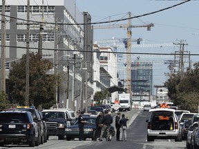 San Francisco Police officers work near where police say a driver got into an altercation with several people and struck them with his vehicle before fleeing in San Francisco, Wednesday, March 28, 2018.  (AP Photo/Jeff Chiu)