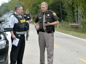 In this Sept. 27, 2017 photo, Isabella County Sheriff Michael Main, right, coordinates efforts in a police manhunt to locate a suspect in Michigan. (Lisa Yanick Litwiller /The Morning Sun via AP)