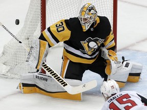 FILE - In this Feb. 13, 2018, file photo, Pittsburgh Penguins goaltender Matt Murray blocks a shot during an NHL hockey game against the Ottawa Senators in Pittsburgh. Matt Murray looks ready to return from a concussion that's kept him out for the last three weeks. Murray practiced with his teammates on Monday, March 19, 2018, and could be available on Tuesday night when the two-time defending Stanley Cup champions visit the New York Islanders.