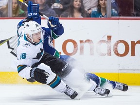San Jose Sharks' Jannik Hansen, front, of Denmark, and Vancouver Canucks' Alex Biega collide during the first period of an NHL hockey game in Vancouver on Saturday March 17, 2018. THE CANADIAN PRESS/Darryl Dyck