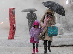 Pedestrians walk along Delancey St. during a snowstorm, Wednesday, March 7, 2018, in New York.  (AP Photo/Mary Altaffer)