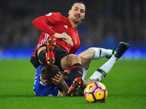 Zlatan Ibrahimovic of Manchester United tangles with Seamus Coleman of Everton as they battle for the ball during the Premier League match between Everton and Manchester United at Goodison Park on Dec. 4, 2016