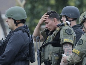 Pomona Police officers watch as the shooting suspect in custody is driven away from an apartment Saturday, March 10, 2018, in Pomona, Calif. (Terry Pierson/The Press-Enterprise via AP)