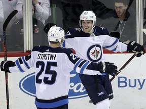 Winnipeg Jets left wing Nikolaj Ehlers, right, celebrates his goal with Paul Stastny (25) during a game against the New Jersey Devils, Thursday, March 8, 2018, in Newark, N.J. (AP Photo/Julio Cortez)