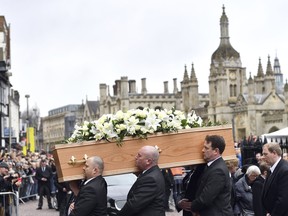 The coffin of Professor Stephen Hawking arrives at University Church of St Mary the Great as mourners gather to pay their respects, in Cambridge, England, Saturday March 31, 2018. The renowned British physicist died peacefully on March 14 at the age of 76. (Joe Giddens/PA via AP)