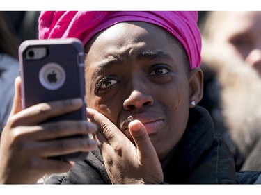 A member of the audience becomes emotional as Zion Kelly, of Washington, who lost his twin brother Zaire to gun violence in the nation's capital in 2017, speaks during the "March for Our Lives" rally in support of gun control in Washington, Saturday, March 24, 2018.