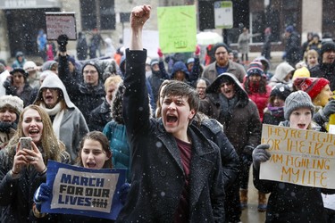 John Collins, 19, a University of Cincinnati student, cheers outside city hall during the "March for Our Lives" protest for gun legislation and school safety, Saturday, March 24, 2018, in Cincinnati. Students and activists across the country planned events Saturday in conjunction with a Washington march spearheaded by teens from Marjory Stoneman Douglas High School in Parkland, Fla., where over a dozen people were killed in February. (AP Photo/John Minchillo) ORG XMIT: OHJM121