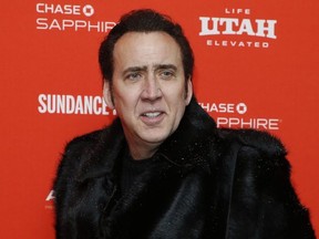 FILE - In this Jan. 19, 2018 file photo, actor Nicolas Cage poses at the premiere of "Mandy" during the 2018 Sundance Film Festival in Park City, Utah. Cage will be voicing Superman in the upcoming film "Teen Titans GO! to the Movies."