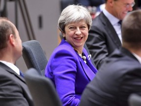 British Prime Minister Theresa May, centre, attends a roundtable meeting at an EU summit at the Europa building in Brussels on Thursday, March 22, 2018.