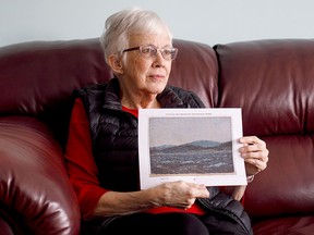 Glenna Gardiner holds a picture of her painting in Edmonton on Wednesday March 28, 2018. THE CANADIAN PRESS/Jason Franson