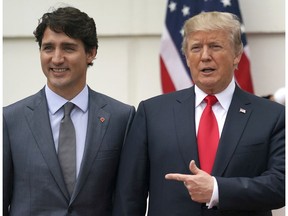 President Donald Trump and Canadian Prime Minister Justin Trudeau poses for a photo as Trudeau arrives at the White House in Washington, Wednesday, Oct. 11, 2017.