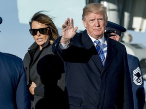 President Donald Trump, accompanied by first lady Melania Trump, waves to members of the media as they arrive at Andrews Air Force Base, Md., Saturday, March 3, 2018 to board Marine One for a short trip to the White House.