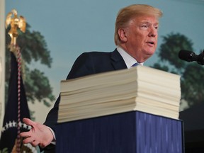 U.S. President Donald Trump speaks in the Diplomatic Room of the White House in Washington, Friday, March 23, 2018, about the US$1.3-trillion spending bill. (AP Photo/Pablo Martinez Monsivais)