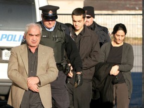 Mohammad Shafia (left), his wife Tooba Mohammad Yahya and their son Hamed arrive for court in Kingston on December 12 2011.