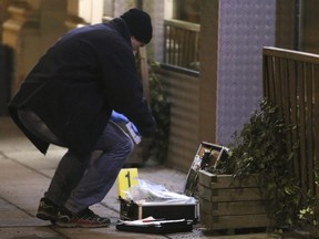A forensic expert secures evidence after several people were been injured in a knife attack on the streets of Vienna, Austria, Wednesday, March 7, 2018.