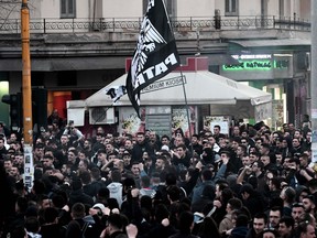 PAOK football club supporters wave banners as they demonstrate in Thessaloniki on March 8, 2018, while protesting against the decision by Greece's Super League to dock their team three points over last month's clash with Olympiakos