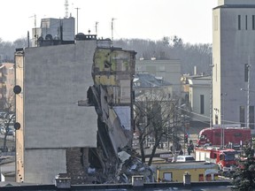 Rescuers work at a collapsed building  in Poznan, Poland, Sunday, March 4, 2018.