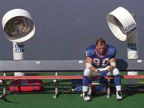 In this Sept. 14, 1997, file photo, New York Giants linebacker Corey Widmer sits on the team bench after losing to the Baltimore Ravens at Giants Stadium in East Rutherford, N.J. (AP Photo/Norm Sutaria, file)