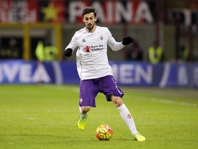 In this Sunday, Jan. 17, 2016 filer, Fiorentina's Davide Astori goes for the ball during the Serie A soccer match between AC Milan and Fiorentina at the San Siro stadium in Milan, Italy.