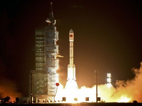 In this Sept. 29, 2011, file photo, a Long March-2FT1 carrier rocket loaded with China's Tiangong-1 space station blasts off from the launch pad at the Jiuquan Satellite Launch Center in Gansu Province.