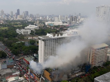 Firemen battle a fire that engulfs the Manila Pavilion Hotel and Casino Sunday, March 18, 2018 in Manila, Philippines. (AP Photo/Bullit Marquez)