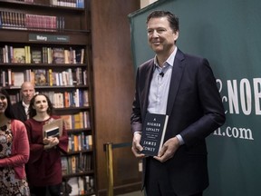 Former FBI Director James Comey poses for photographs as he arrives to speak about his new book "A Higher Loyalty: Truth, Lies, and Leadership" at Barnes & Noble bookstore, April 18, 2018 in New York City.