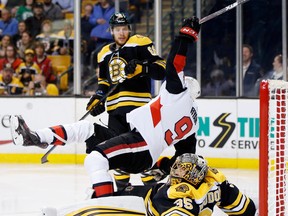 Ottawa Senators' Bobby Ryan collides with Boston Bruins' Anton Khudobin during Saturday night's game. (AP PHOTO)