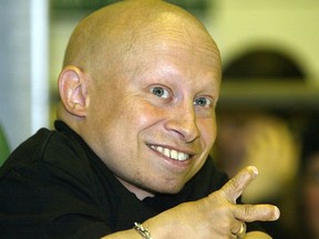 Verne Troyer, who played 'Mini-me' in the Austin Powers movies, mugs for a photograph at the World of Wheels on Sat., April 10, 2004 at the Winnipeg Convention Centre.