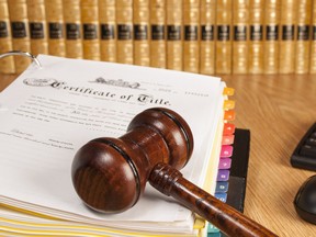 judge gavel on legal documents with law books and computer keyboard in the background