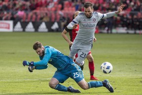 Chicago Fire's Nemanja Nikolic (right) collides with Toronto FC goalkeeper Alex Bono during Saturday's game. (THE CANADIAN PRESS)