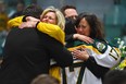 Mourners comfort each other during a vigil at the Elgar Petersen Arena, home of the Humboldt Broncos, to honour the victims of a fatal bus accident, April 8, 2018 in Humboldt, Canada. Mourners in the tiny Canadian town of Humboldt, still struggling to make sense of a devastating tragedy, prepared Sunday for a prayer vigil to honor the victims of the truck-bus crash that killed 15 of their own and shook North American ice hockey. / AFP PHOTO / POOL / JONATHAN HAYWARDJONATHAN HAYWARD/AFP/Getty Images
