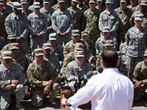 Members of the Arizona National Guard listen to Arizona Gov. Doug Ducey on April 9, 2018 at the Papago Park Military Reservation in Phoenix, Arizona.