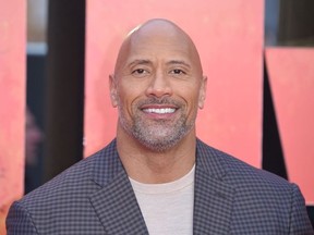 US actor Dwayne Johnson poses on the carpet arriving for the European premiere of the film Rampage in London on April 11, 2018.