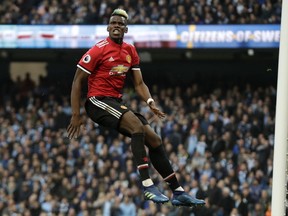 Manchester United's Paul Pogba reacts after scoring his side's second goal during the English Premier League soccer match between Manchester City and Manchester United at the Etihad Stadium in Manchester, England, Saturday April 7, 2018.