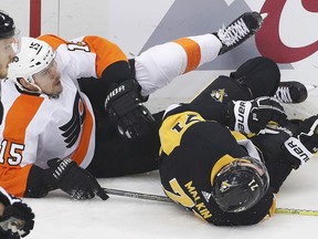 Pittsburgh Penguins star Evgeni Malkin (71) and Philadelphia Flyers' Jori Lehtera (15) slide into the boards during Game 5 in Pittsburgh, Friday, April 20, 2018.