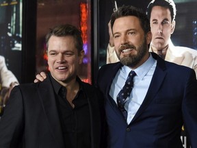 Ben Affleck, right, the director, writer, producer and star of "Live by Night," poses with actor Matt Damon at the premiere of the film at the TCL Chinese Theatre on Monday, Jan. 9, 2017 in Los Angeles.