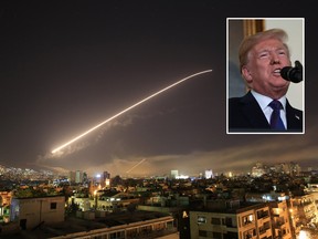 The Damascus sky lights up missile fire as the U.S. launches an attack on Syria targeting different parts of the capital early Saturday, April 14, 2018. Syria's capital has been rocked by loud explosions that lit up the sky with heavy smoke as U.S. President Donald Trump announced airstrikes in retaliation for the country's alleged use of chemical weapons. (AP Photo/Hassan Ammar)