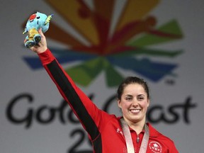 Canada's Women's 63Kg Weightlifting Gold medalist Maude Charron, waves after the medal ceremony at the Commonwealth Games in Gold Coast, Australia, Saturday, April 7, 2018.