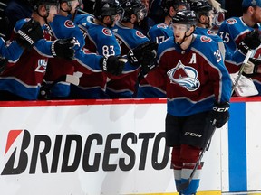 Colorado Avalanche centre Nathan MacKinnon, front, is congratulated after scoring a goal against the Nashville Predators on April 16, 2018