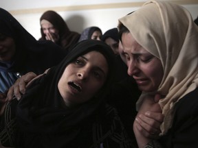 Relatives react to 15-year old Palestinian boy, Azzam Hillal (Owidah), at the family home during his funeral in Khan Younis, southern Gaza Strip, Saturday, April 28, 2018.  The Palestinian Health Ministry in Gaza says a boy has died a day after being hit by an Israeli gunshot in the head. (AP Photo/ Khalil Hamra)