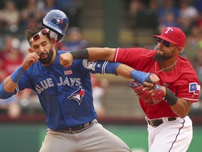 Toronto Blue Jays Jose Bautista (19) is punched by Texas Rangers second baseman Rougned Odor (12) after Bautista slid into second base in the eighth inning of a baseball game at Globe Life Park in Arlington, Texas, Sunday May 15, 2016. (RICHARD W. RODRIGUEZ/The Canadian Press/Star-Telegram via AP)