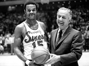 In this Jan. 29, 1971, file photo, Hal Greer of the Philadelphia 76ers, accepts a ball from Sixers owner Irv Kosloff after Greer reached 20,001 points during a basketball game against the Milwaukee Bucks